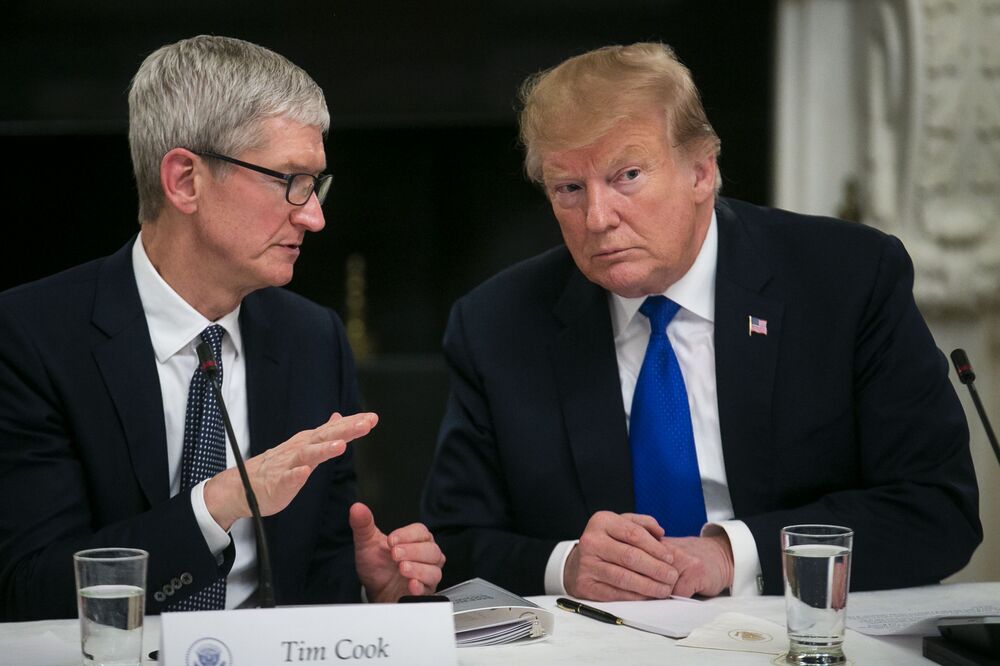 U.S. President Donald Trump speaks with Tim Cook, chief executive officer of Apple Inc..