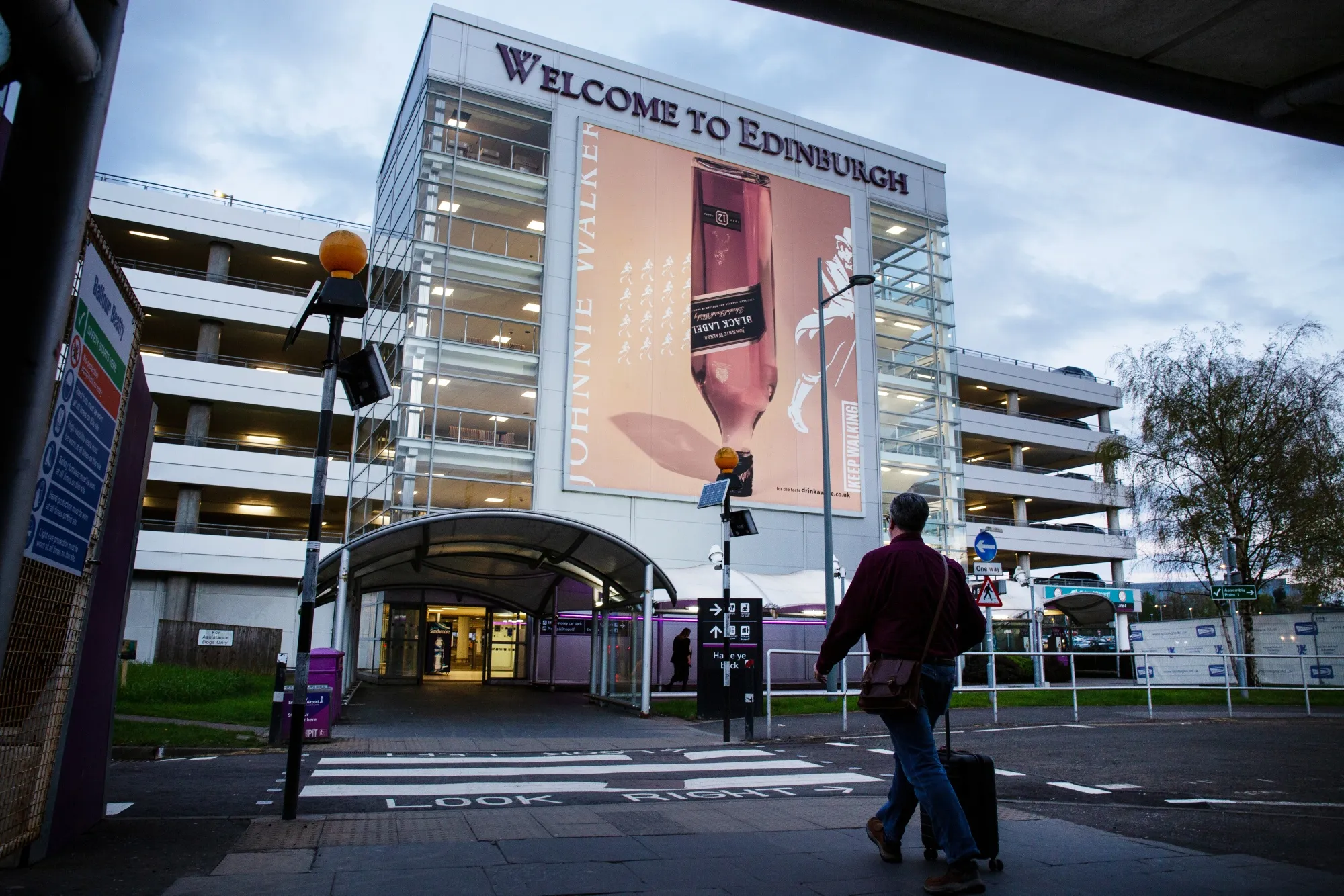 A traveler walks Tuesday toward&nbsp;the carparks at Edinburgh Airport in Edinburgh, UK.