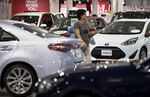 Toyota Motor Corp. vehicles including the Aqua hybrid, right, stand on display at the Toyota Mega Web showroom in Tokyo, Japan.