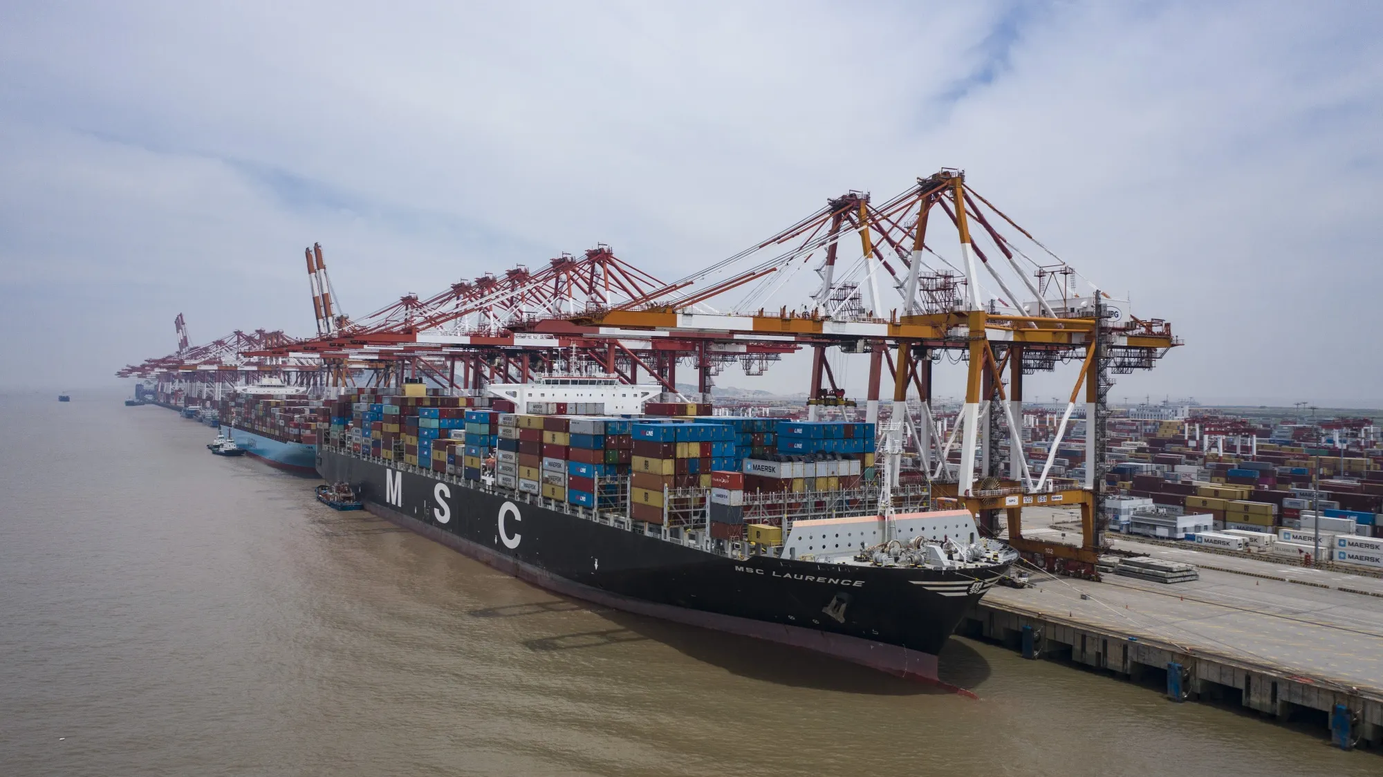 Vessels loading with shipping containers at a port in Shanghai in July.
