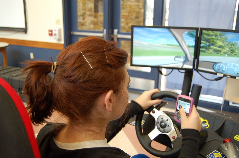 A high-school senior practices on a texting-while-driving simulator. 