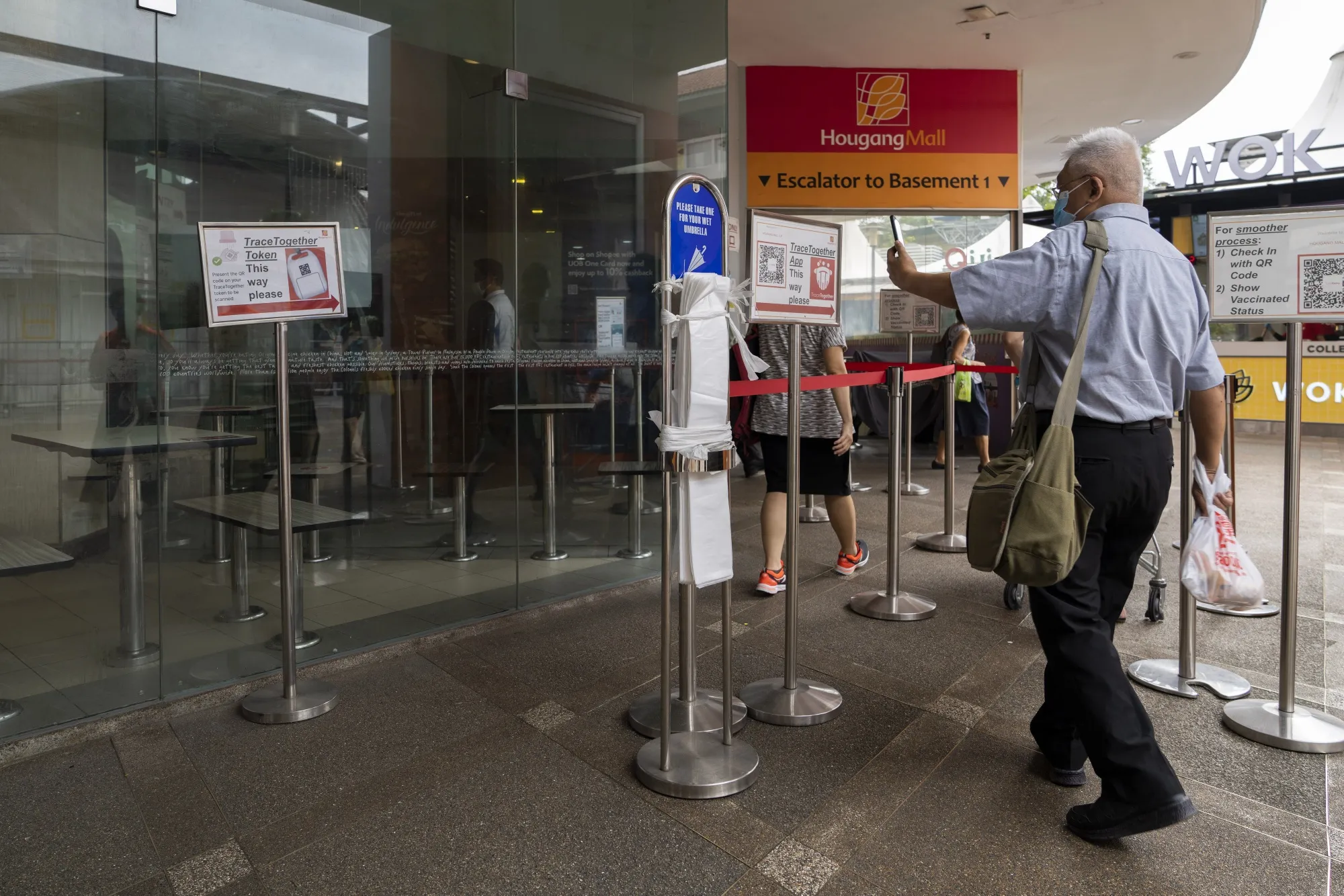 A visitor uses the Trace Together contact-tracing app to enter a market in Singapore, on Dec. 22.