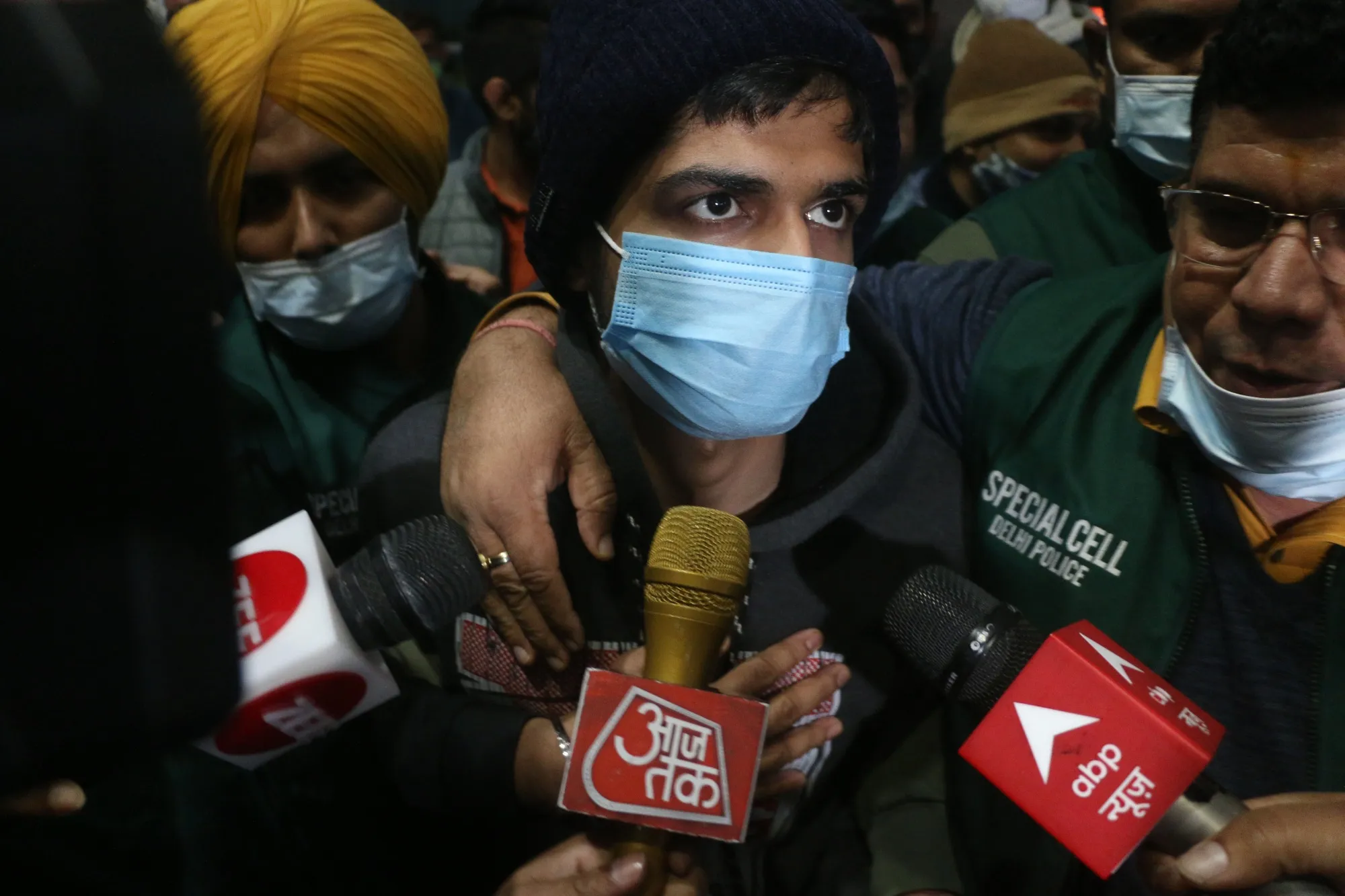 Niraj Bishnoi, center, with Delhi Police Special Cell officers at Delhi airport on Jan. 6.