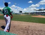 Boston Red Sox' Jeter Downs waits to bat during a spring training baseball game against the Minnesota Twins at JetBlue Park in Fort Myers, Fla., Thursday, March 17, 2022. The Boston Red Sox wore St. Patrick's Day green for their spring debut. (AP Photo/Jake Seiner)
