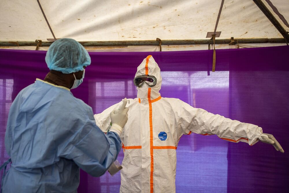 A health worker disinfects a colleague after testing patients for Covid-19 at a field hospital near Nairobi on May 4.