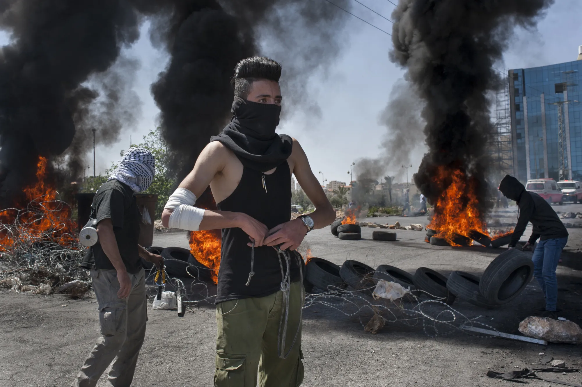 A Palestinian protesters readies his slingshot near Beit El, in Ramallah, West Bank,&nbsp;in April 6.