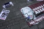 Banners in support of Julian Assange lie on the ground outside the Westminster Magistrates' Court in London.