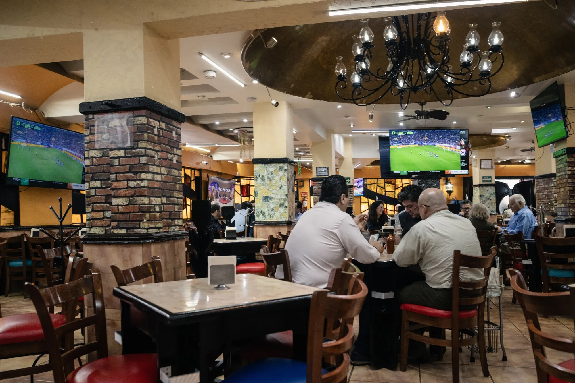 Diners watch sports on the Tudn channel on a television at a restaurant in Mexico City.