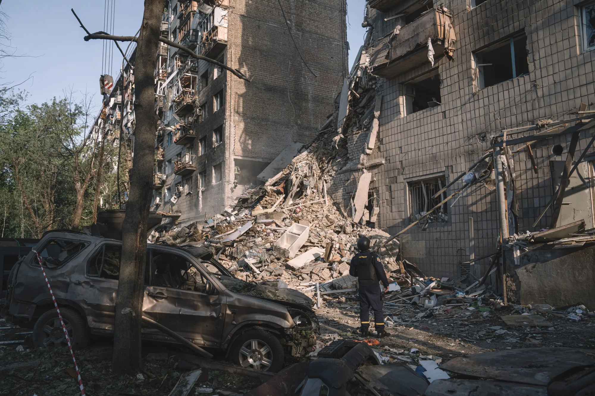 Rescue services search&nbsp;wreckage after an air strike on a residential building in Kyiv.