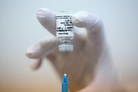 A heath worker draws from a vial of Sputnik V Covid-19 vaccine at a clinic in Moscow.