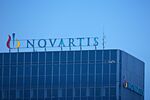 The Novartis AG Logo sits on top of the company's headquarters office in Basel, Switzerland, on Wednesday, Jan. 25, 2017. Novartis proposed buying back $5 billion of shares and said it's considering separating its embattled eye-care division after projecting that sales this year at Europe's second-biggest drugmaker will likely be largely unchanged from 2016.
