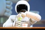 Honda's ASIMO robot tries to pour itself a drink.
