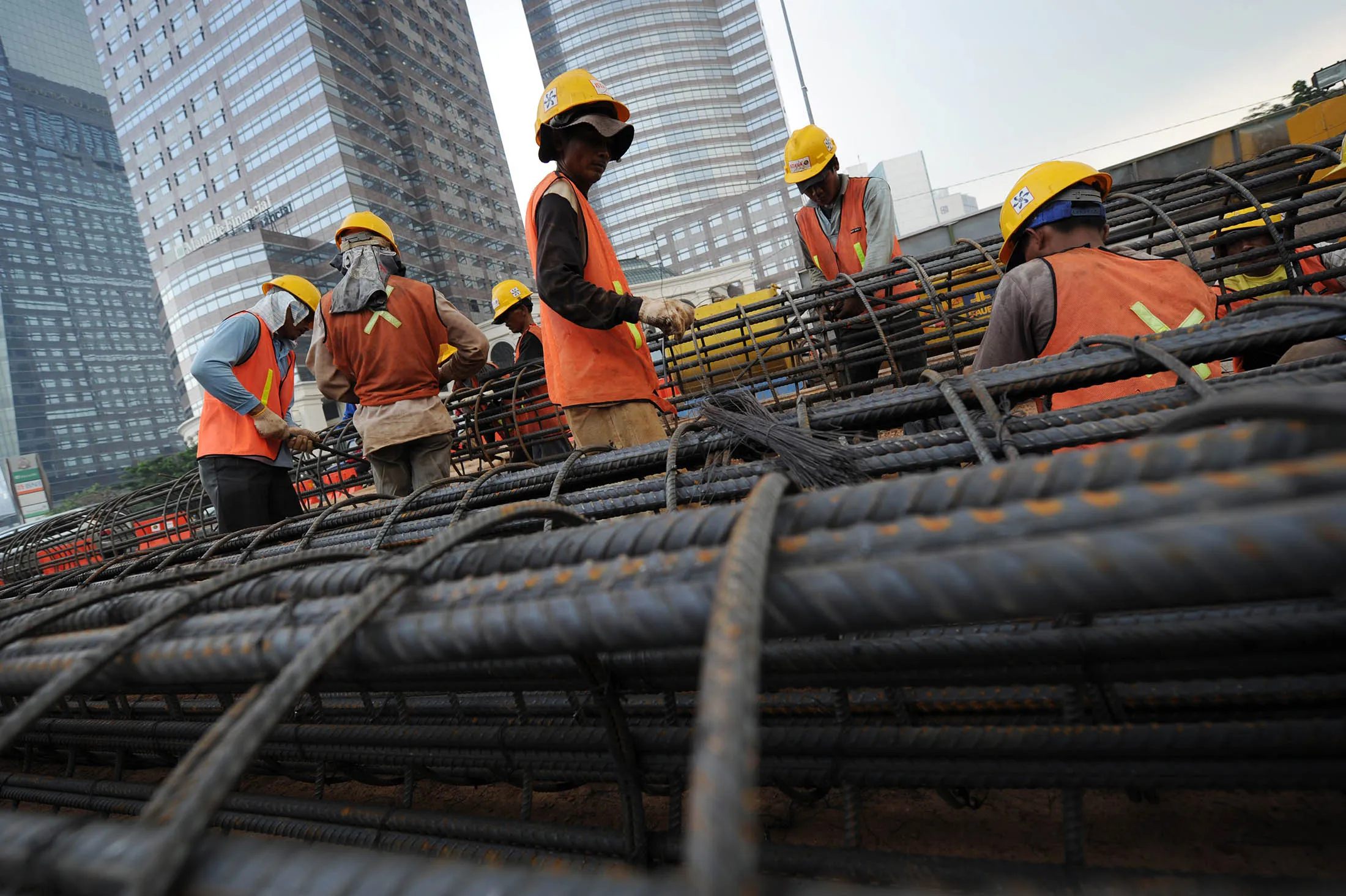 Workers prepare iron reinforcement bars