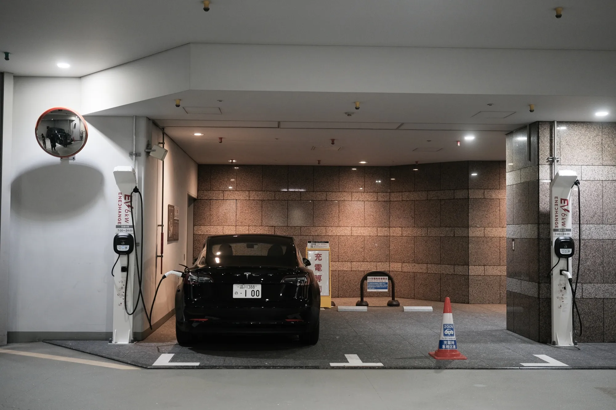 A lone Tesla charges in the basement of a commercial property in&nbsp;Tokyo.&nbsp;&nbsp;