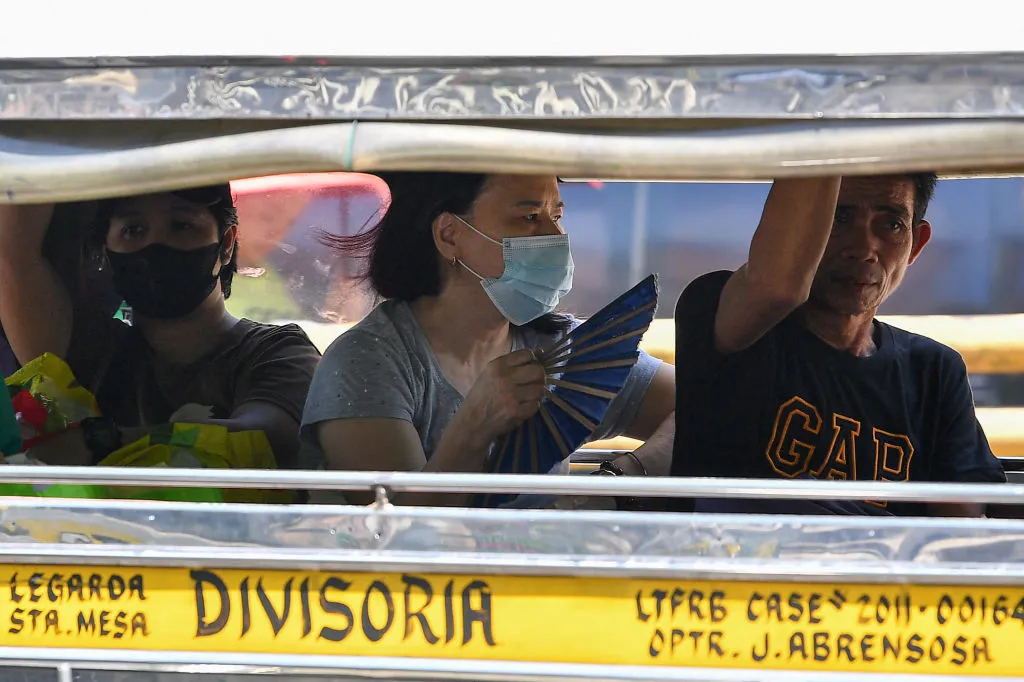 A woman cools off&nbsp;inside a passenger jeepney in Manila.&nbsp;