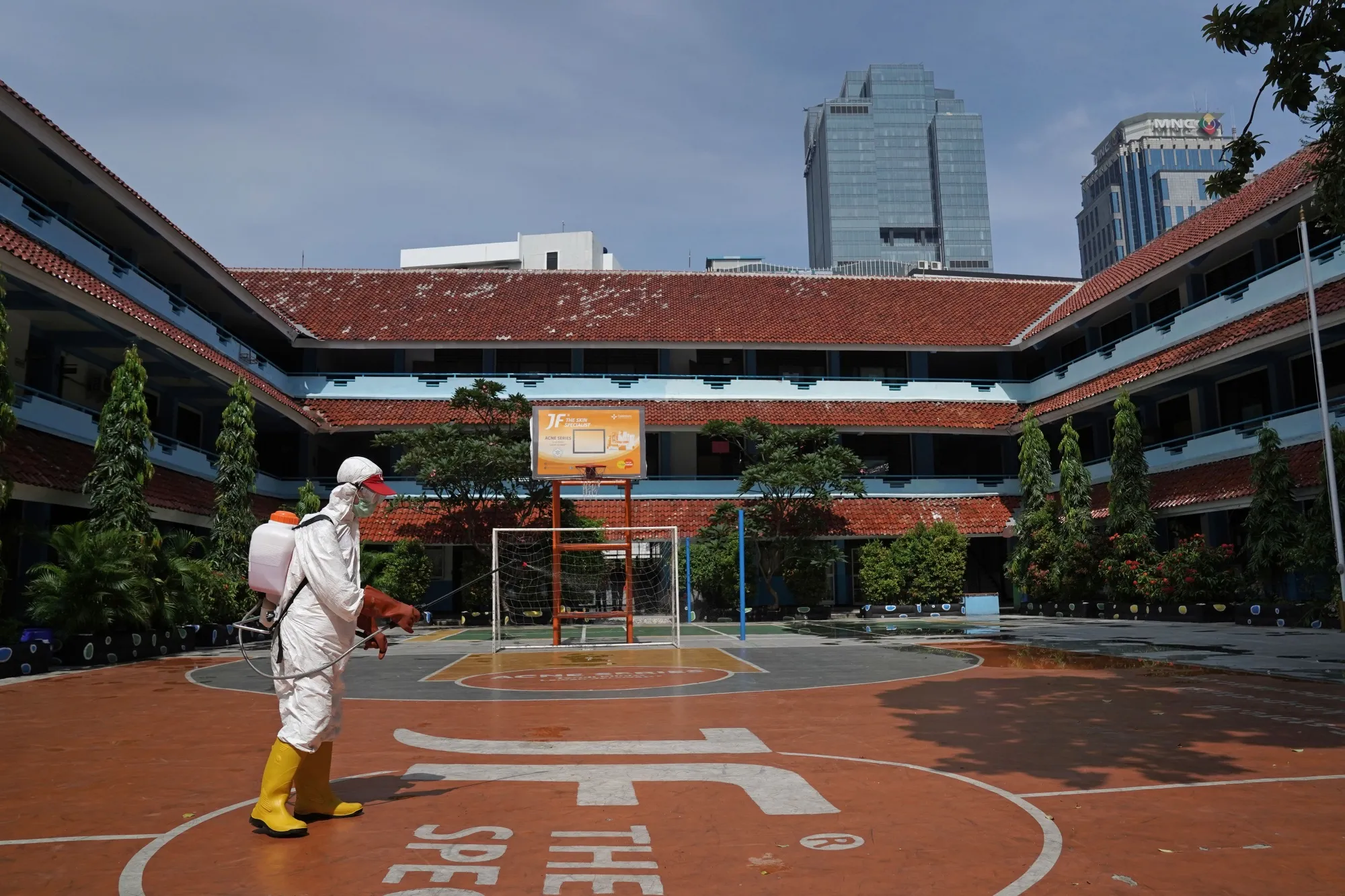 A member of the Indonesian Red Cross Society&nbsp;sprays disinfectant at a&nbsp;school in Jakarta, on March 20.