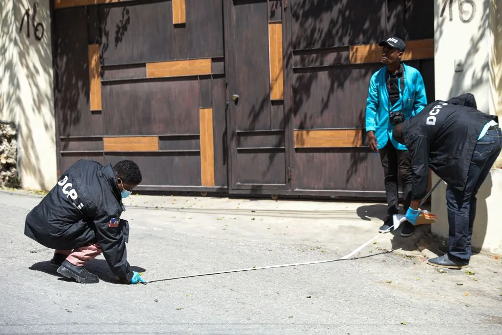 Looking for evidence outside of the presidential residence in Port-au-Prince.