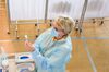 A medical worker prepares a syringe with the AstraZeneca vaccine at a community sports hall converted into a vaccination center in Ventspils, Latvia.