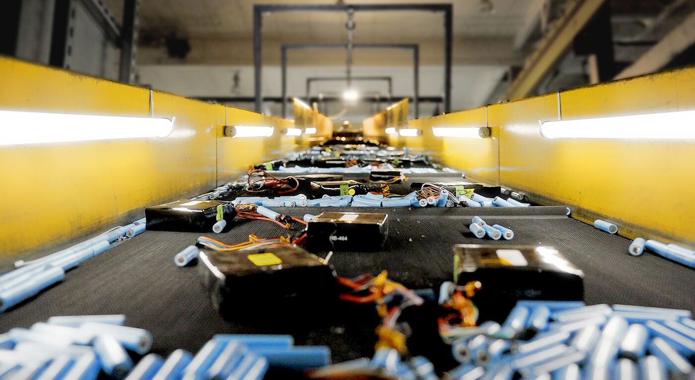 Lithium-ion batteries on conveyor belt at Li-Cycles Spoke facility in Rochester, New York.