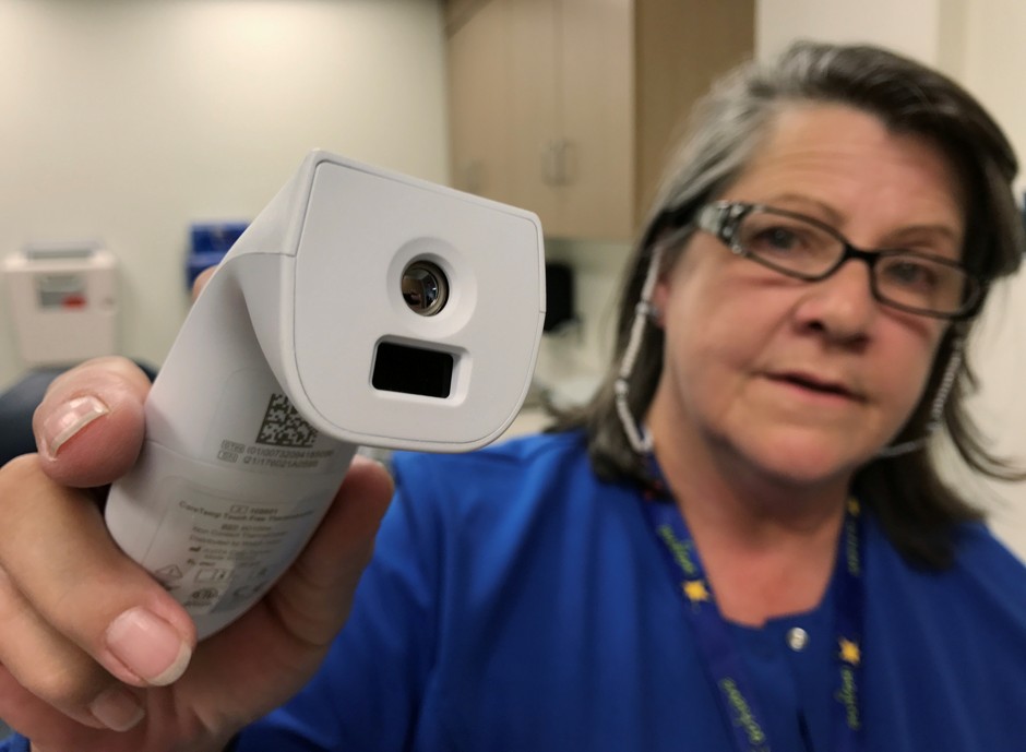 Registered nurse Tara McCormick demonstrates an infrared thermometer at West Virginia University Hospital in Morgantown, West Virginia on September 6, 2017.