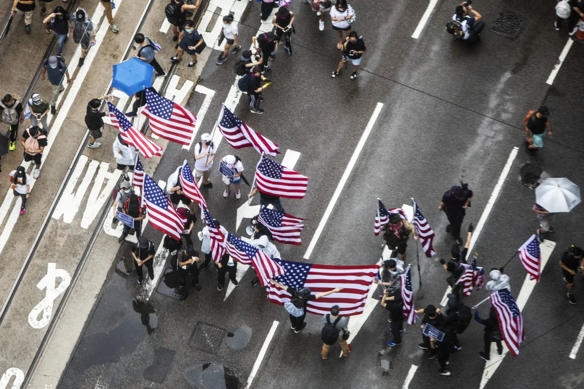 Demonstrators wave American flags on Queensway during a protest in the Central district of Hong Kong, Aug. 31.&nbsp;
