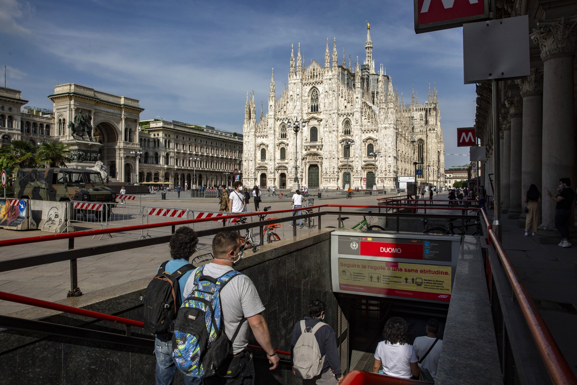 Passengers enter the Duomo metro station in the Cathedral square in Milan.