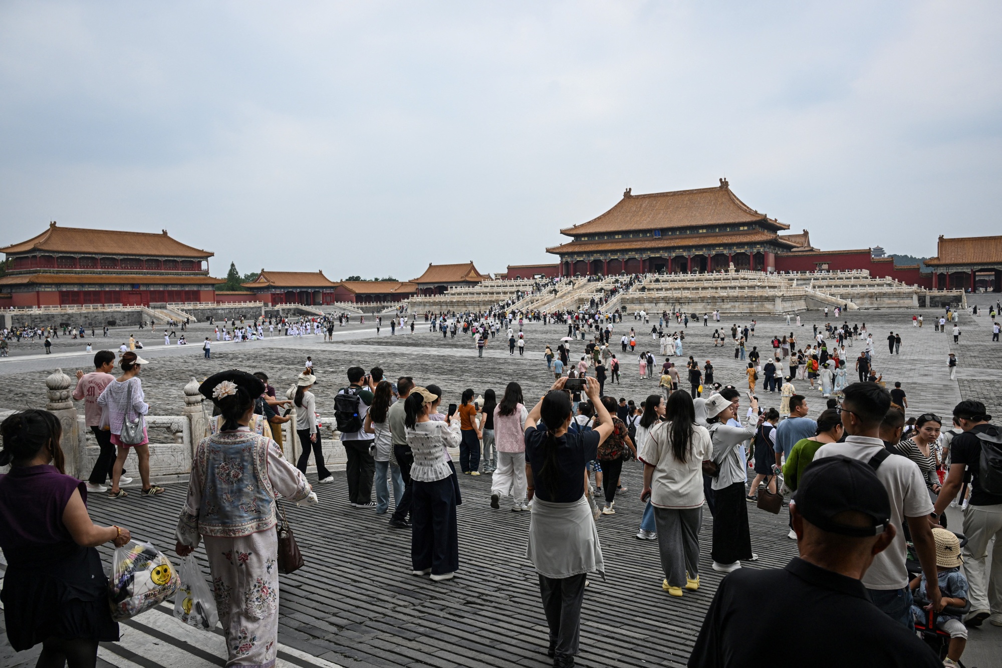 People visit the Forbidden City in Beijing. Photographer: Jade Gao/AFP/Getty Images