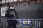 A Turkish police officer stands guard close to the site of an armed attack near the Reina night club.