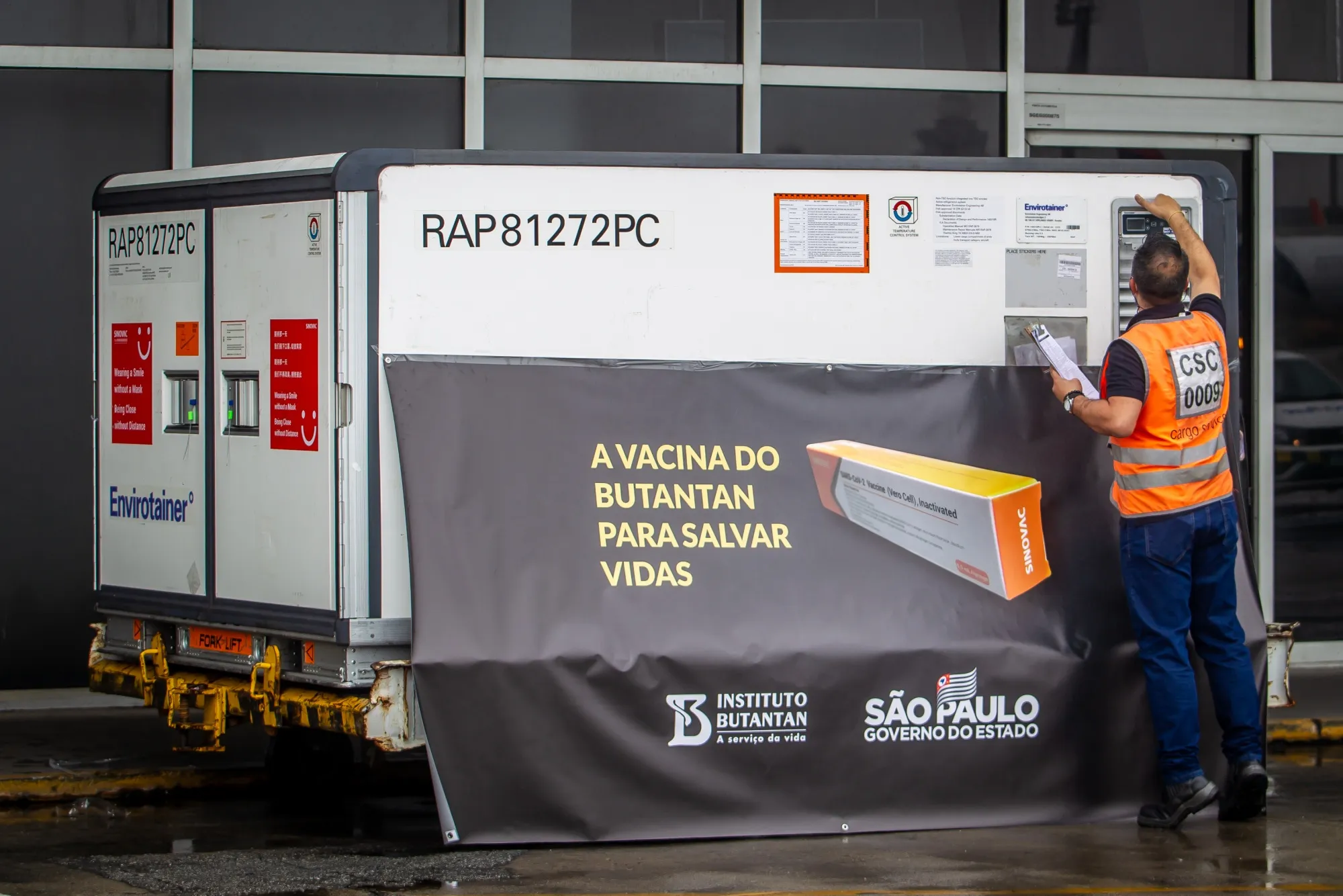 A Butantan institute worker checks a refrigerated container carrying Sinovac coronavirus vaccines at Guarulhos International Airport in Sao Paulo, Brazil, on Nov. 19, 2020.