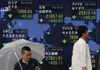 Pedestrians walk past an electoronic board showing share prices on the Tokyo Stock Exchange (top C) and the world's major markets in Tokyo on August 13, 2018. - Tokyo's benchmark Nikkei index dropped nearly two percent on August 13 as Turkey's lira plunged on tensions between Ankara and Washington, fanning fears of possible wider financial instability. (Photo by Kazuhiro NOGI / AFP) (Photo credit should read KAZUHIRO NOGI/AFP/Getty Images)