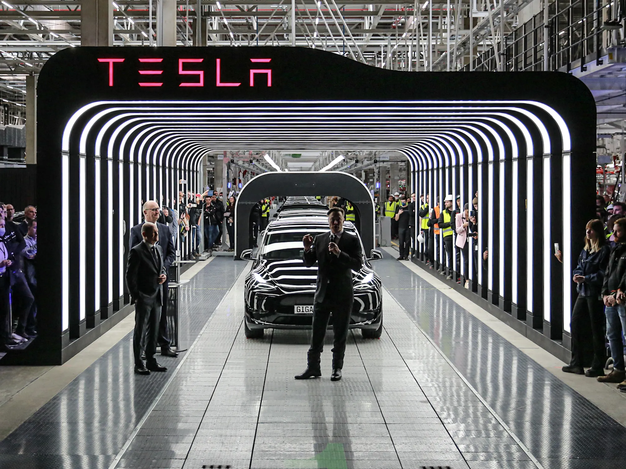 Elon Musk, center, and Olaf Scholz, left, attend the start of production at the Tesla Gigafactory in Gruenheide, Germany, on March 22.
