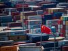 A Chinese flag is seen in front of containers at the Yangshan Deep-Water Port, an automated cargo wharf, in Shanghai on April 9, 2018. - China warned that trade talks with the United States were "impossible" under current conditions after President Donald Trump reassured markets by suggesting that the dispute could be resolved. (Photo by Johannes EISELE / AFP) (Photo credit should read JOHANNES EISELE/AFP/Getty Images)