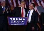 U.S. President-elect Donald Trump, center, embraces Reince Priebus, chairman of the Republican National Committee, on stage during an election night party at the Hilton Midtown hotel in New York, on Nov. 9, 2016.
