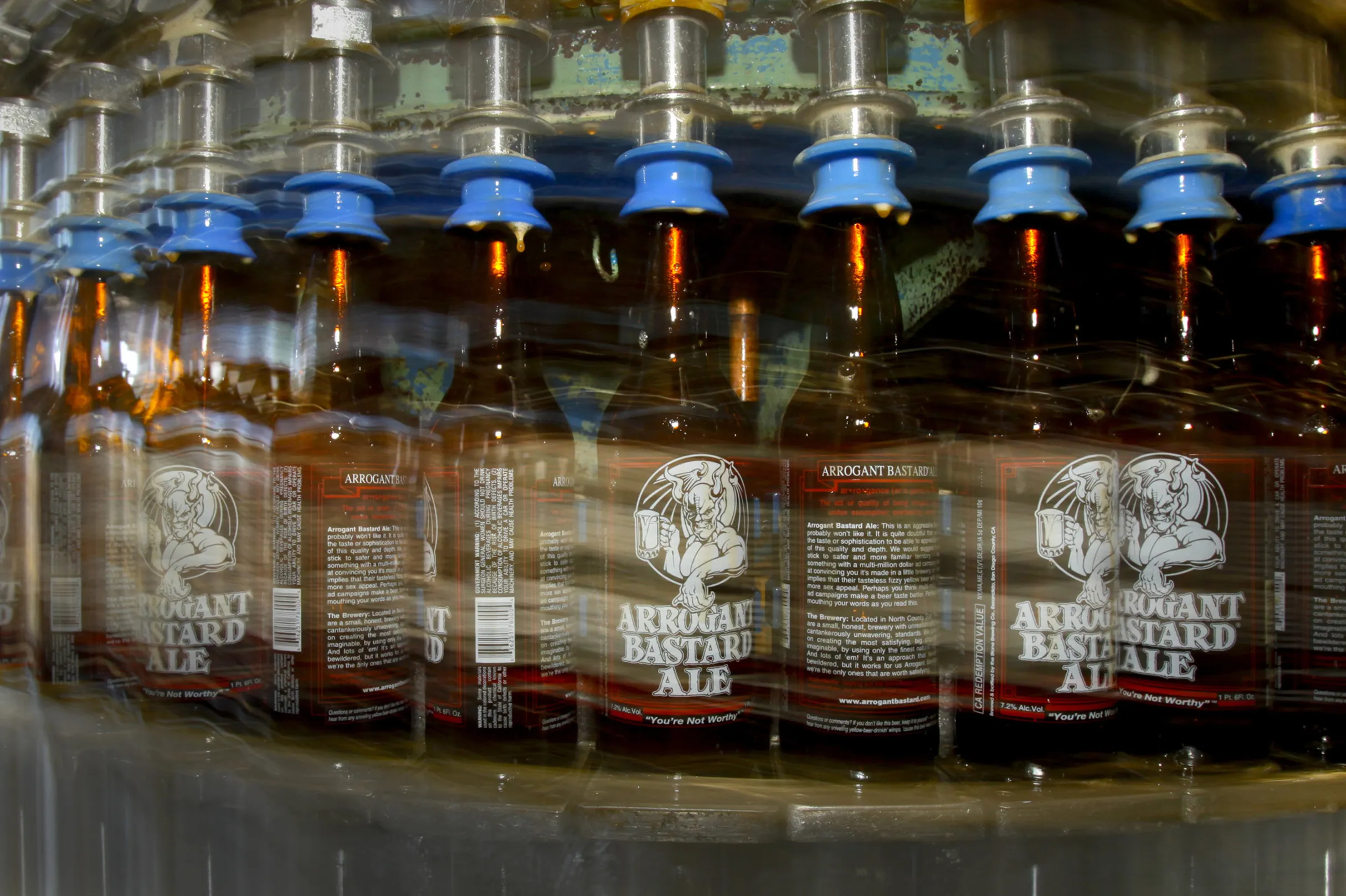 Bottles of Arrogant Bastard Ale move along the production line at Stone Brewing Company in Escondido.
