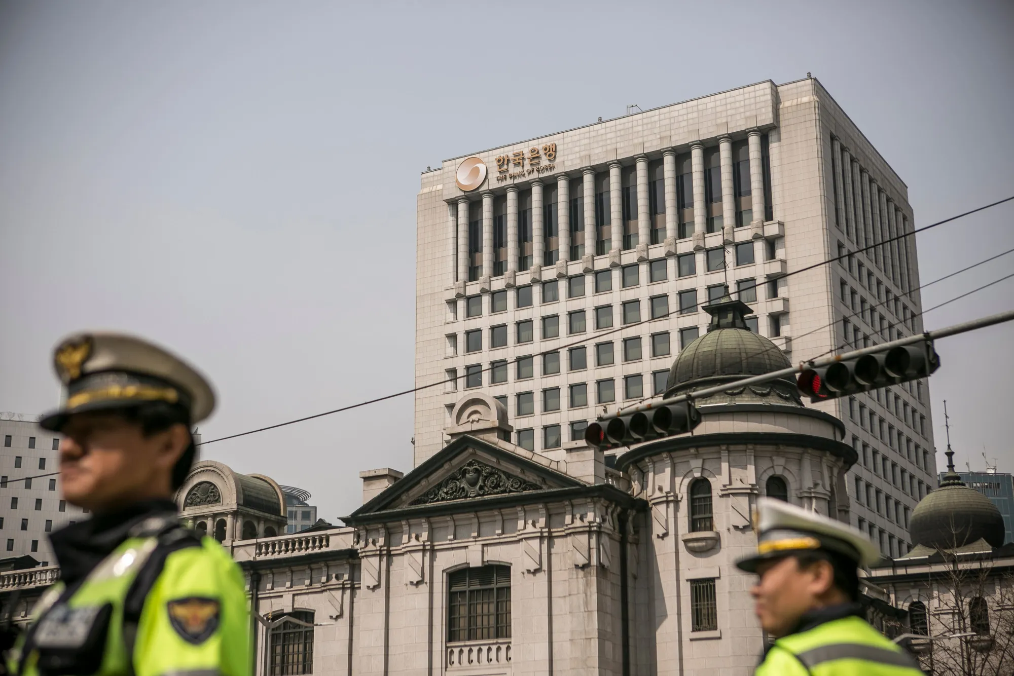 Police officers stand in front of the Bank of Korea headquarters building in Seoul, South Korea.