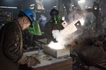 Employees pour molten magnesium out of a crucible and into a mold at the Lite Metals Co. foundry in Ravenna, Ohio, U.S., on Wednesday, Sept. 20, 2017. The Lite Metals Co. is a magnesium and aluminum foundry, producing sand castings primarily for the helicopter and racing industries.
