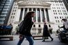 Pedestrians pass in front of Wall Street near the New York Stock Exchange (NYSE) in New York, U.S., on Monday, Oct. 22, 2018.