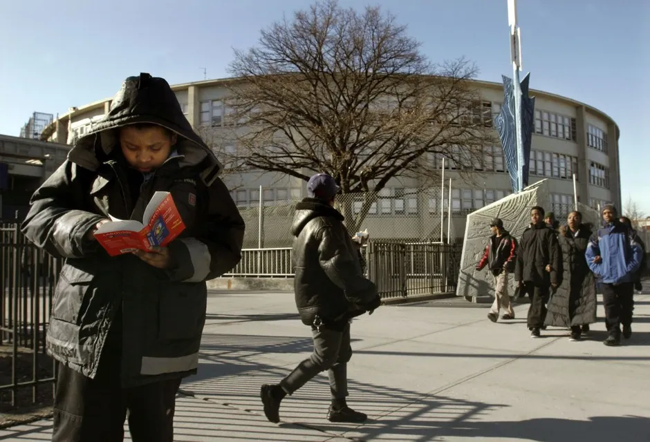 A student checks his dictionary after classes let out at Wingate High School in Brooklyn, phased out in 2006.