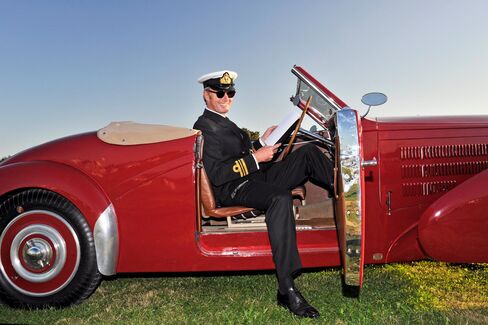 Wearing his late father’s Royal Navy uniform, Simon Kidston sits in his 1938 Bugatti Type 57C Cabriolet at this year’s Goodwood Revival.