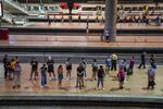 Passengers wait for a train at Atocha rail station in Madrid, Spain.