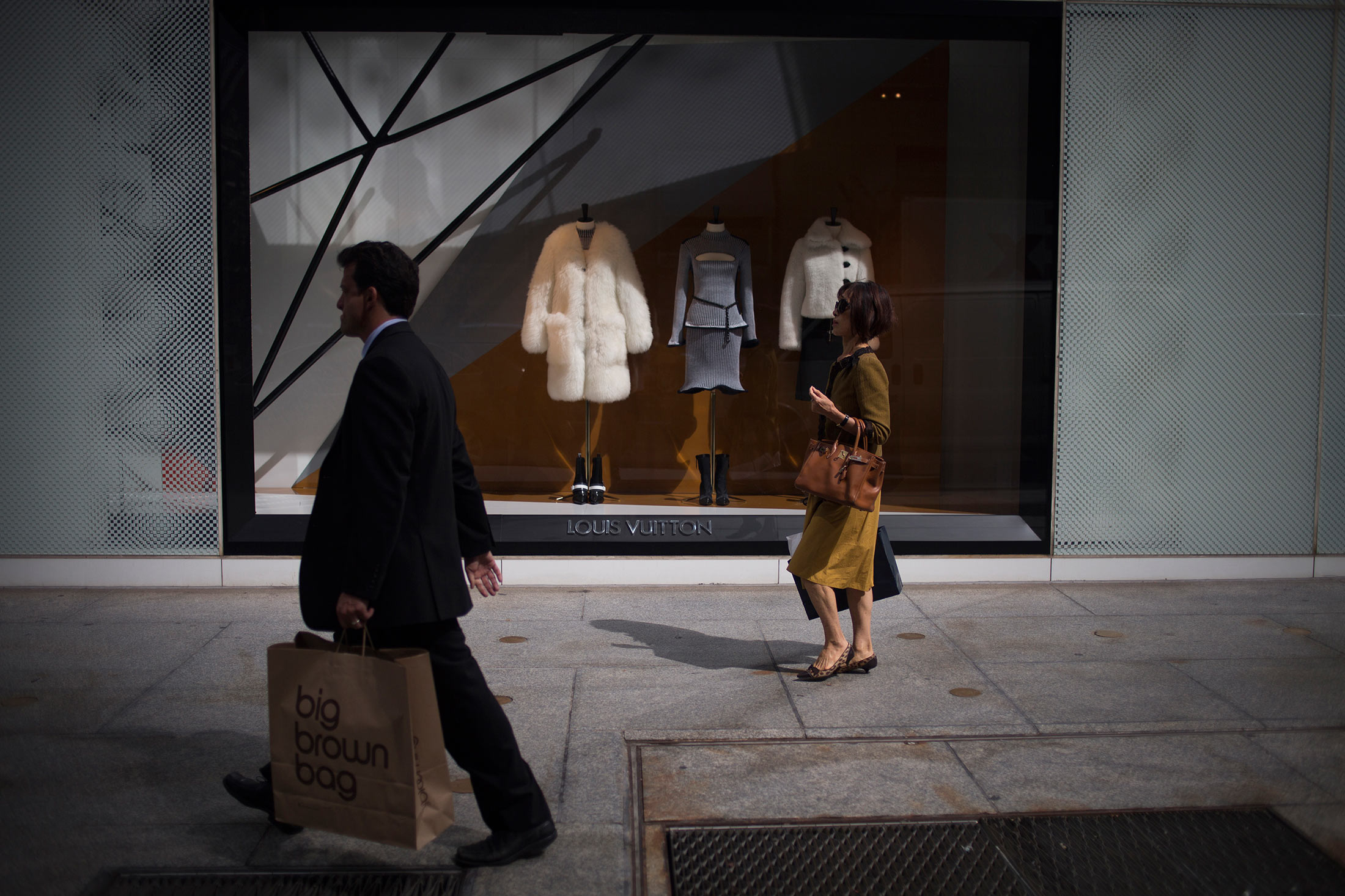 Pedestrians walking past the Louis Vuitton store on 5th avenue