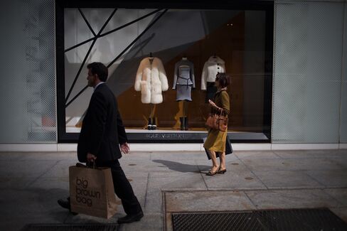 Pedestrians walk past a Louis Vuitton store on Fifth Avenue in New York, on Sept. 21, 2015.