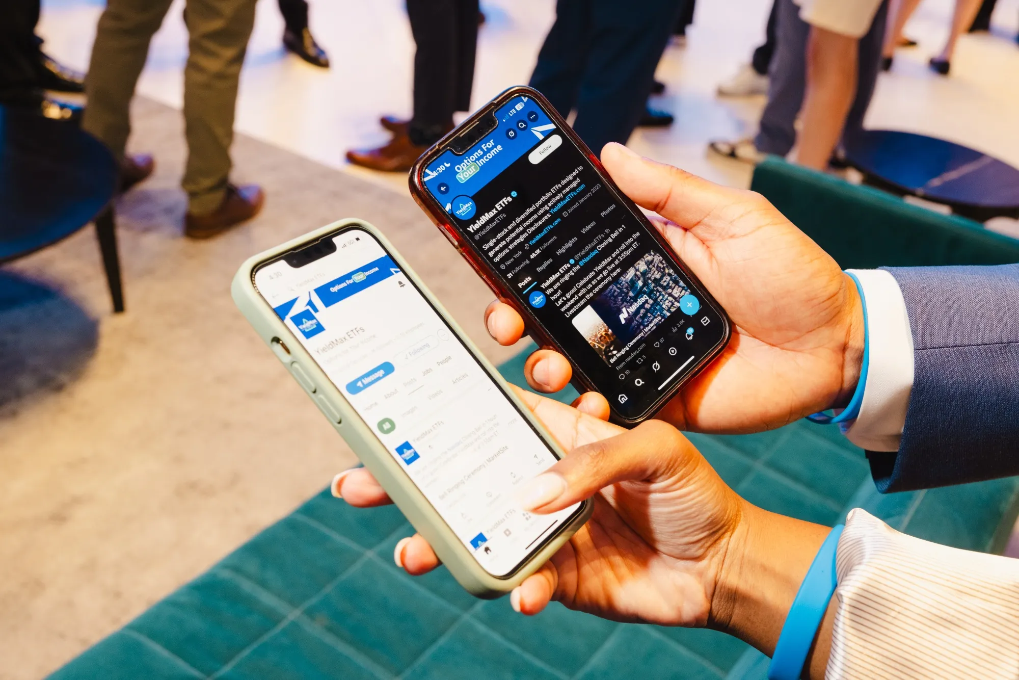 Two iPhones are held out, one displays a LinkedIn page for YieldMax ETFs, the other shows the @YieldMaxETFs X account.