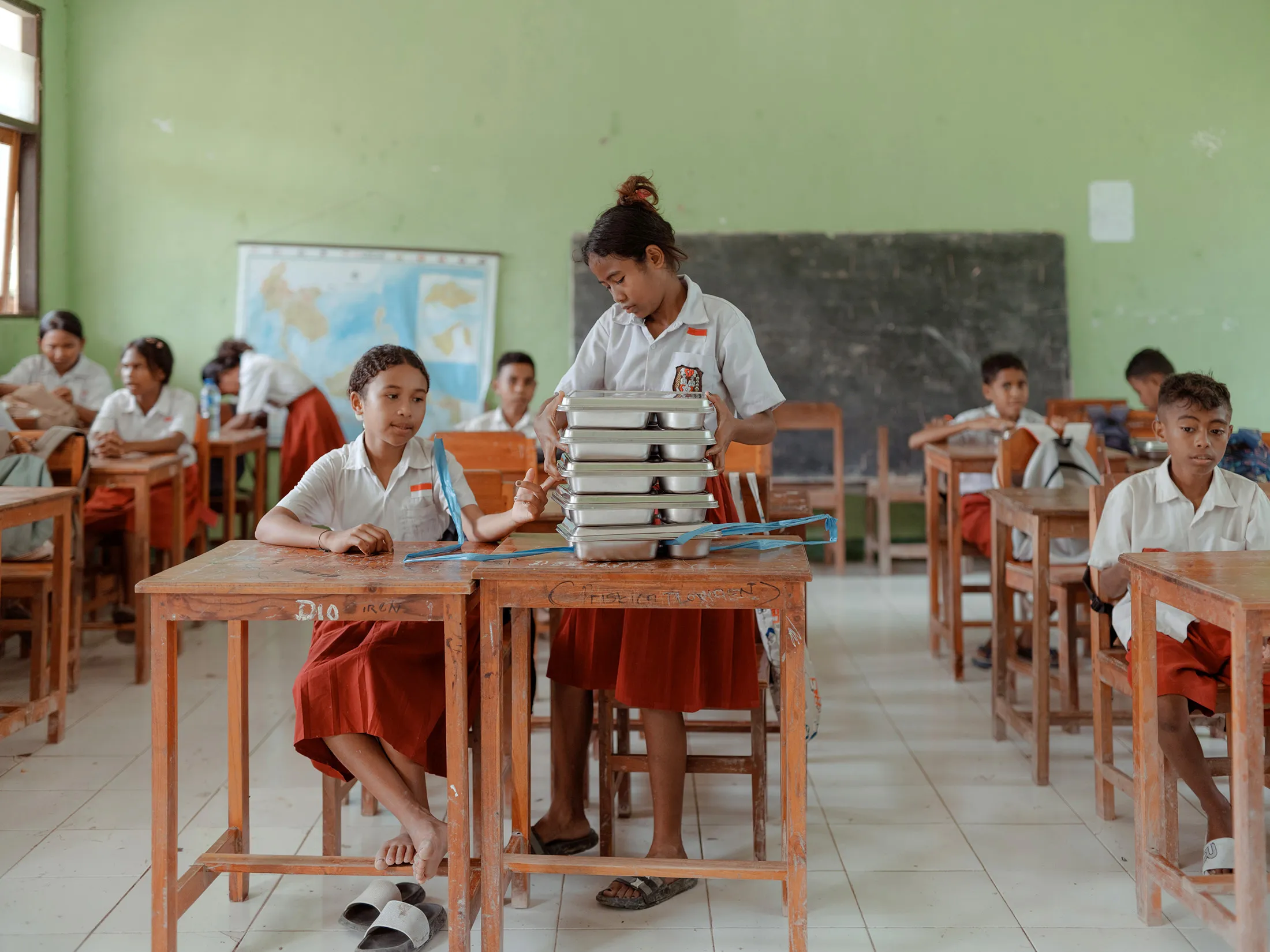 School children receive free meals at an elementary school in Toineke, East Nusa Tenggara, Indonesia in March.
