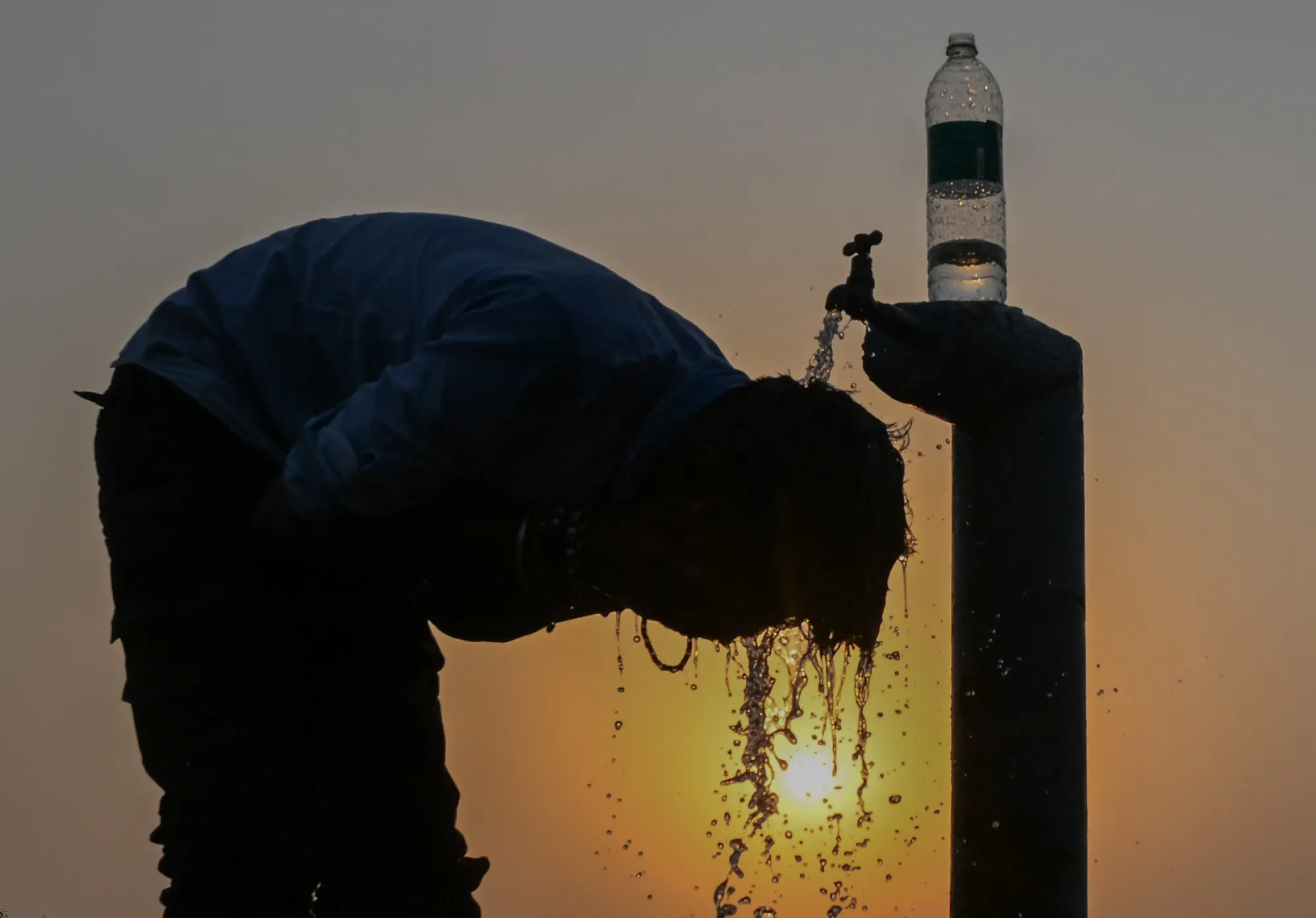A man cools himself with water during hot weather in Allahabad, India on May 21, 2026.&nbsp;