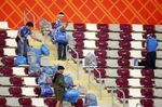 Japanese fans clear rubbish from the stands during the FIFA World Cup match between Germany and Japan in Doha, on Nov. 23.