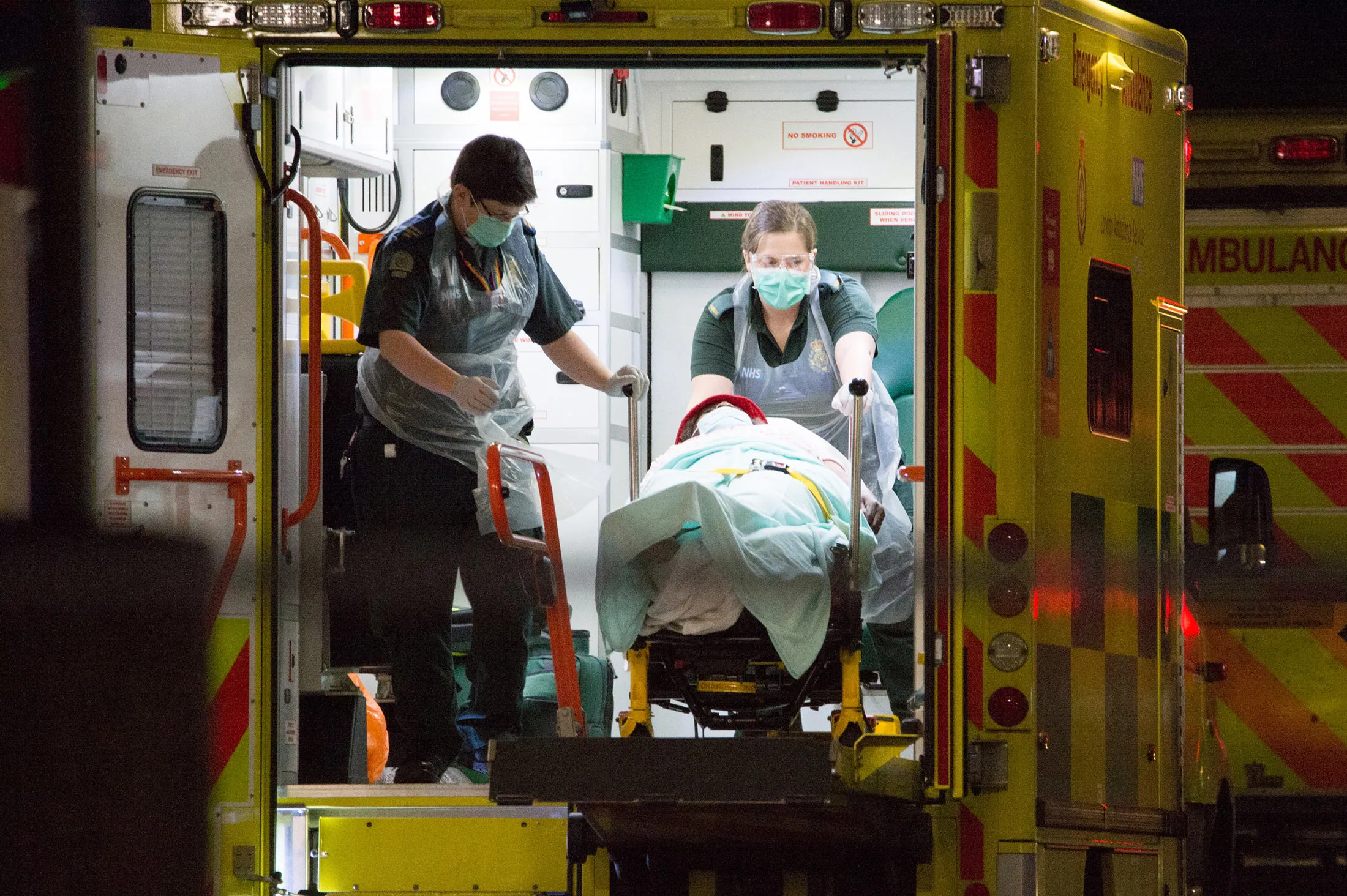 Ambulance workers transport a patient&nbsp;outside St. Thomas’ Hospital in London, on April 7.