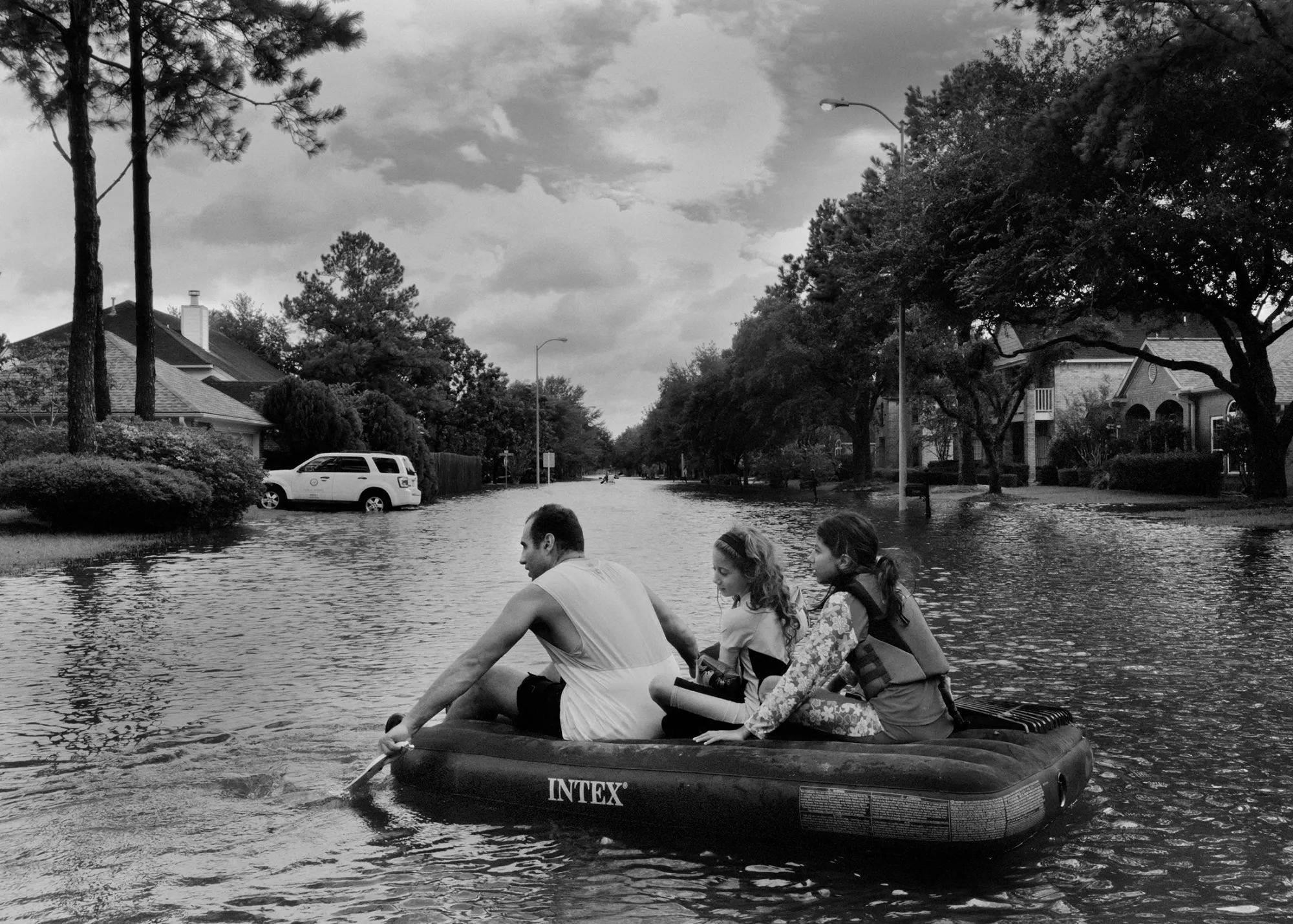 A family in Katy, just west of Houston, floats on an inflatable mattress.