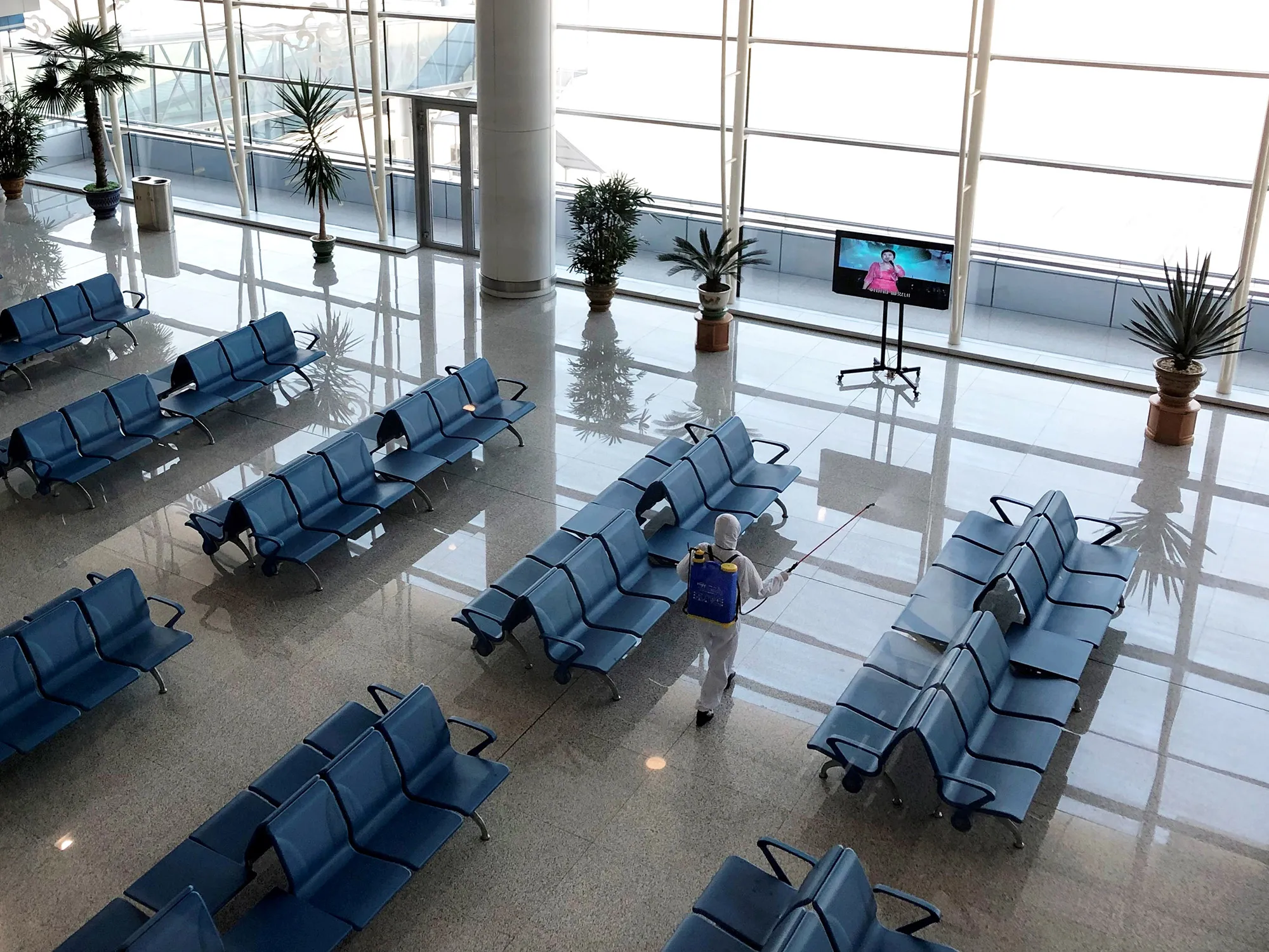 An employee disinfects&nbsp;public spaces at Pyongyang International Airport on March 9.&nbsp;