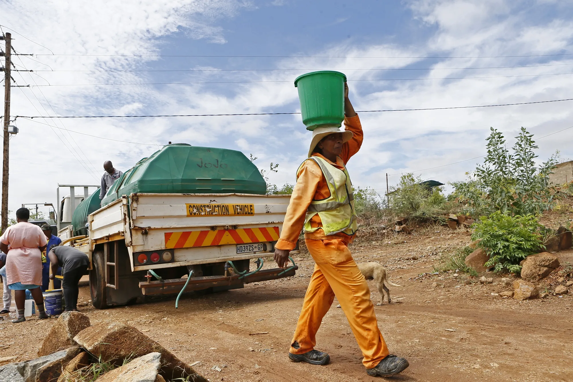 A resident carries water from a tanker in Hammanskraal, South Africa, on Nov. 13.